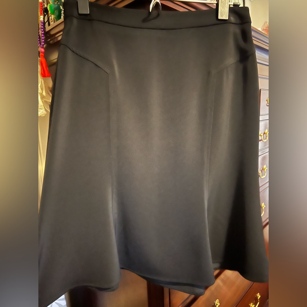 Beautiful black polyester mid length skirt. It comes a little above my shins.